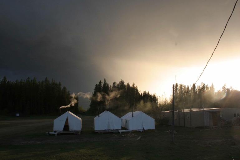canvas tents and a moody sky